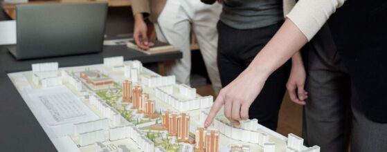 Architects examining city model in office